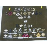 BOARD OF ASSORTED CAP BADGES INCLUDING GURKHAS