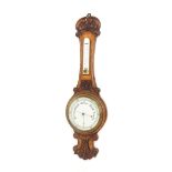 Oak barometer/thermometer, within a foliate and C-scroll carved case (a.f)