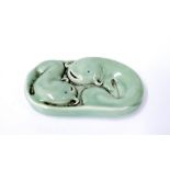 Small Chinese porcelain paperweight in the form of two coiled fish, calligraphy seal mark to base,