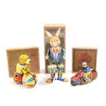 Three tinplate clockwork toys to include a drumming rabbit, dog with ball and motorbike, each with