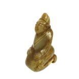 Chinese carved jade of a kneeling figure with gold highlights, 3" high