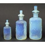 Good Sabino graduated set of three scent bottles embossed with Art Deco type pin-ups, the largest