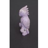 Carved lavender jade, modelled as a Cockatoo perched on a rock, 6cm high