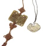 Pierced jade medallion decorated with fish, upon brown string, the medallion 3.5" x 2.75";