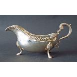 Georgian style silver gravy boat with gadrooned rim, S-scroll handle and scallop shell feet, maker A