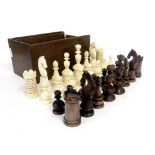 Early 19th century bone and stained bone chess set, height of king 9cm, within a wooden games box