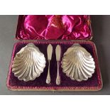 Attractive pair of Victorian silver scallop shell shaped dishes on three ball feet with two fish