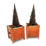 Pair of red lacquered chinoiserie planters fitted with twin handles and simulated bamboo supports,