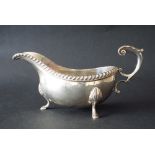Georgian style silver sauce boat with S-scroll handle, gadrooned rim and scallop shell feet, maker A