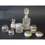 Collection of various silver topped glass bottles, to include a silver rimmed cut glass decanter and