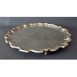 Large silver salver in the Georgian style, with a pie-crust border upon four scrolled feet, maker