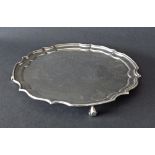 Georgian style silver salver with a pie-crust border upon four scroll feet, maker A Haviland-Nye,