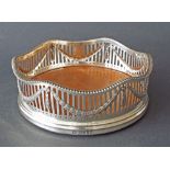 Good Victorian silver and fruitwood wine coaster with raised wavy darted rim over a pierced sleeve