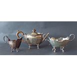 Late Victorian silver three piece tea service with raised scrolled cartouche rims and faceted