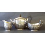 Elkington & Co. silver three piece half fluted tea service, Birmingham 1902, the teapot 7" high, 11"
