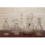 Collection of seven various cut glass decanters, to include a cylindrical decanter etched with fleur