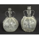 Matched pair of Continental antique glass twin handled globe decanters, decorated with panels of