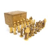 Interesting African carved figural chess set, height of king 8.5cm, within a carved tribal box