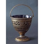 George III silver-gilt basket with beaded swing handle over pierced bowl decorated with scrolled