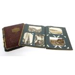 Two vintage postcard albums filled with many travel photographs of village scenes, military, royal