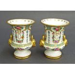 Pair of French porcelain twin-handled vase urns in the manner of Sevres, decorated with various