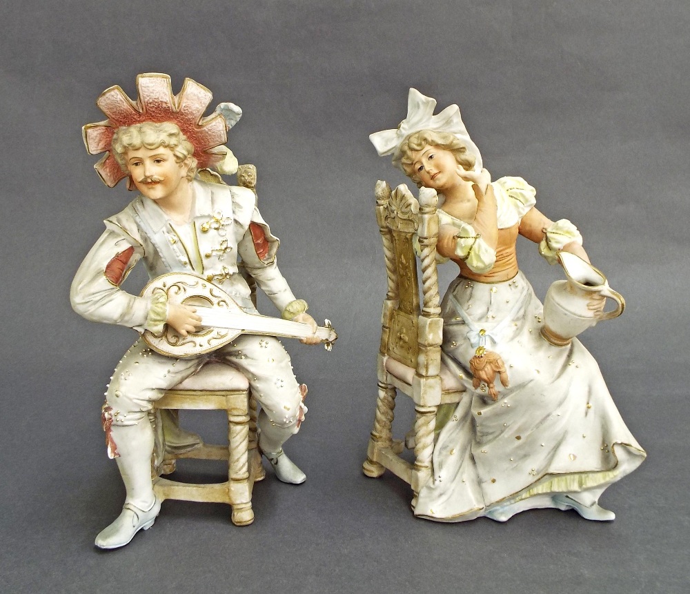 Pair of Continental seated bisque figures of a gentleman playing a mandolin serenading his lady, 10"