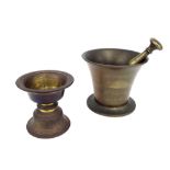 Antique cast brass pestle and mortar, the mortar 4.5" high: together with a further cast bronze