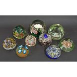 Collection of eight glass paperweights fitted with flowers and millefiori segments, the largest 5.5"