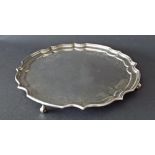 Georgian style silver salver with a pie-crust border upon four scrolled feet, maker A Haviland-