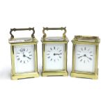 Three similar carriage clock timepieces, within cornice brass cases, all 5.75" high (two with