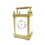 French carriage clock striking on a gong, within an ornate filigree banded case surmounted by a