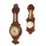 Two carved oak aneroid barometer/thermometers, the largest signed Moore & Co. to the silvered