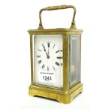 French Henri Jacot carriage clock striking on a gong, within a corniche brass case, 7" high;