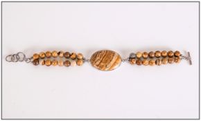 Picture Jasper Bracelet, a large oval cut, bezel set cabochon of picture jasper attached to a double