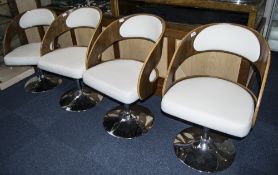 Set of Stylish Designer Dining Chairs with chrome swivel base and teak frame.