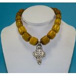A Vintage Amber Necklace with White Metal Pendant Drop. 14 Inches In Length.