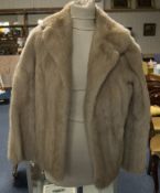 Ladies Short Blond Mink Jacket. Fully lined with hook and eye fastening and slit pockets.