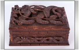 Chinese Carved Wood Casket with a swirling dragon to the lid & further carving to the sides.