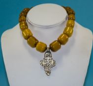 A Vintage Amber Necklace with White Meta