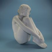 Italian Modern White Marble Figure of a young nude maiden in a seated position.