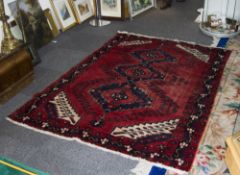 Turkish Wool Rug, predominantly red in colour with geometric navy and cream detail.