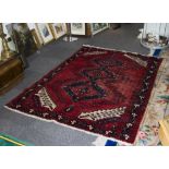 Turkish Wool Rug, predominantly red in colour with geometric navy and cream detail.