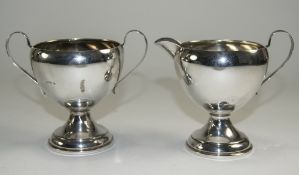 A Pair of Silver Two Handled Sugar Bowl and Milk Jug of Plain Form, Loaded Bases. Marked Sterling.