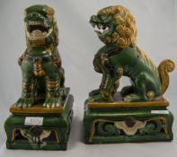 2 Modern Chinese Style Temple Dogs In Green And Beige Ground Raised On Shaped Rectangular Bases,