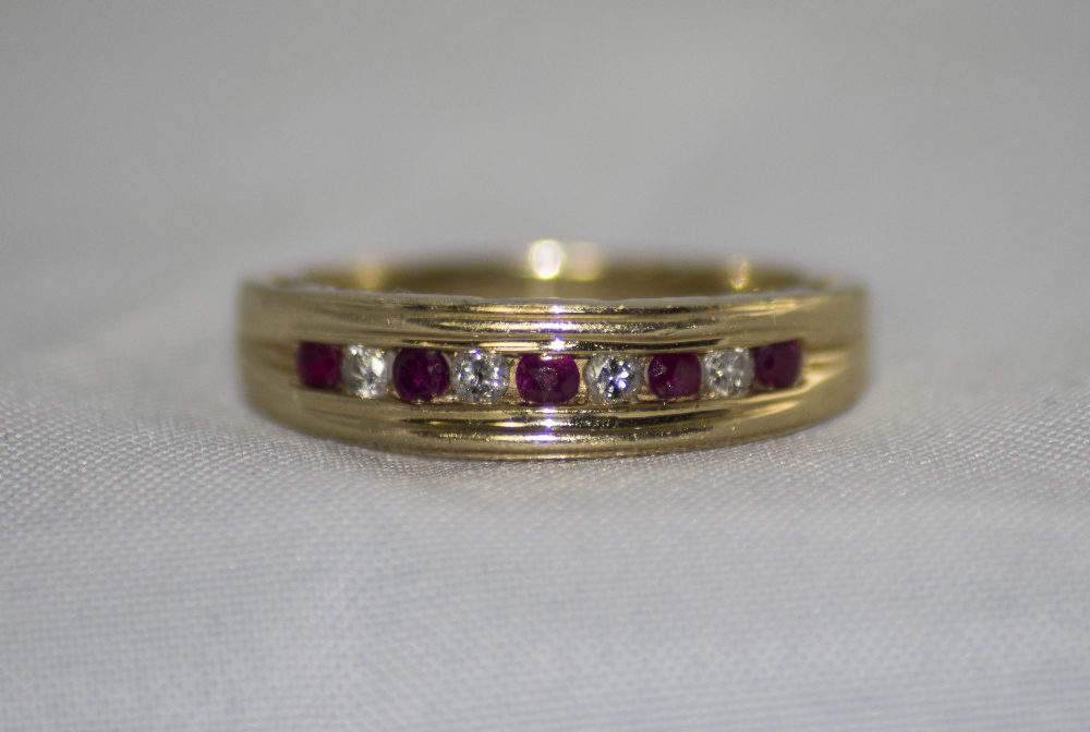 14ct Gold Ruby and Diamond Channel Set Ring. Marked 14 kt.