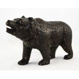 A Carved Black Forest Bear with Glass Eyes. Approx 10.5 Inches Length, 6.5 Inches HIgh.