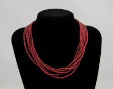 An Antique Six Strand Coral Bead Necklace.