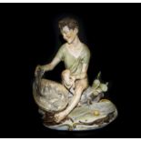 Capodimonte Signed Figure of a Fisherboy, shown seated on a rocky wall, with a large basket of