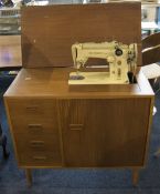 Singer Table Sewing Machine Finished In Teak With Three Drawers, Together With Accessories.