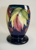 William Moorcroft Signed Vase ' Leaves and Berries ' Design on Blue Ground. c.1920's. 6 Inches High.